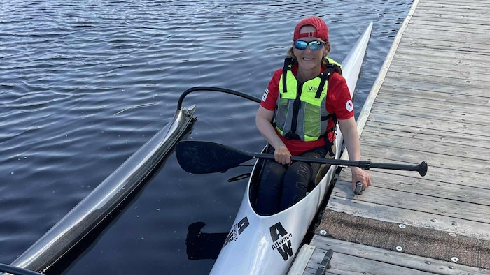 It smiles on board the boat, which has a float on the side to maintain balance.