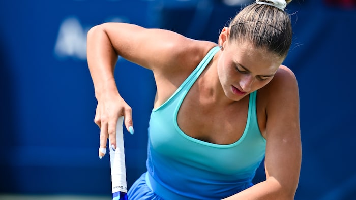La joueuse de tennis met un genou à terre.