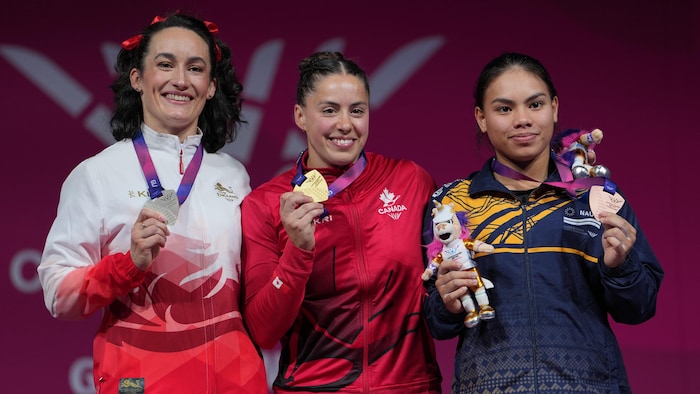 Elle se tient sur le podium aux côtés de ses adversaires.