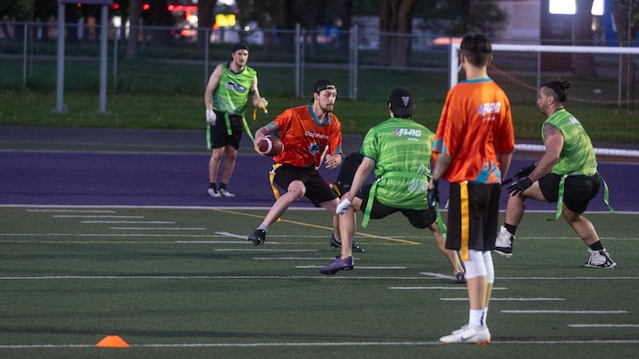 Des joueurs de flag football sont en action sur le terrain.