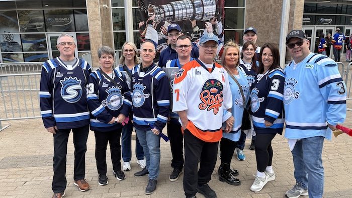 Gens avec gilets des Saguenéens prenant la pose pour la photo.