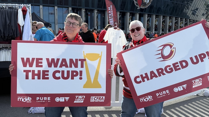 Deux partisanes de hockey montrent leur appui à leur équipe avant un match.