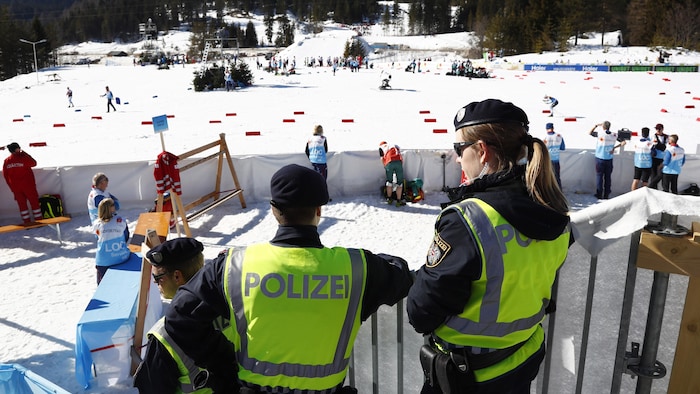 Des policiers autrichiens surveillent l'action dans la zone d'arrivée aux mondiaux de ski de fond à Seefeld. 