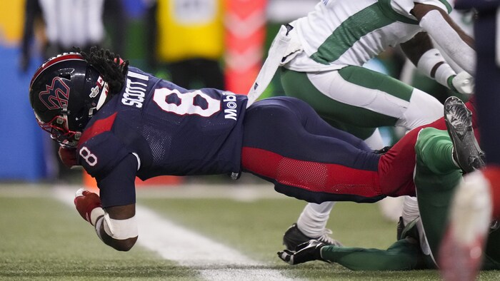 A football player enters the end zone.