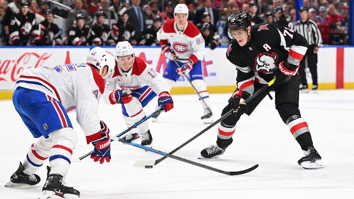 Un joueur de hockey tente d'en déjouer un autre.