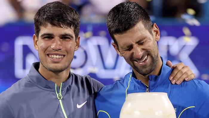 Two players pose with the trophy.