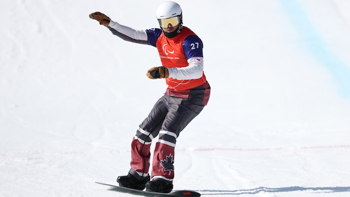 Tyler Turner franchit la ligne d'arrivée avec un bras dans les airs aux Jeux paralympiques de Milan-Cortina.