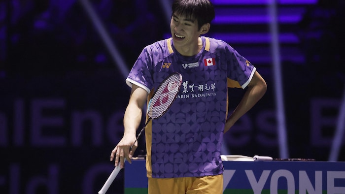 The badminton player smiled after a successful blow in a match.