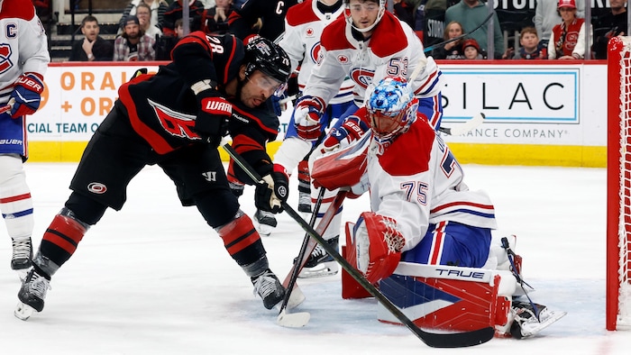 Un hockeyeur tente de déjouer un gardien, en vain.