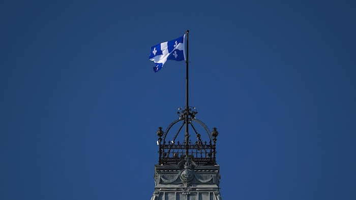 Un drapeau au sommet de l'édifice de l'Assemblée nationale du Québec.