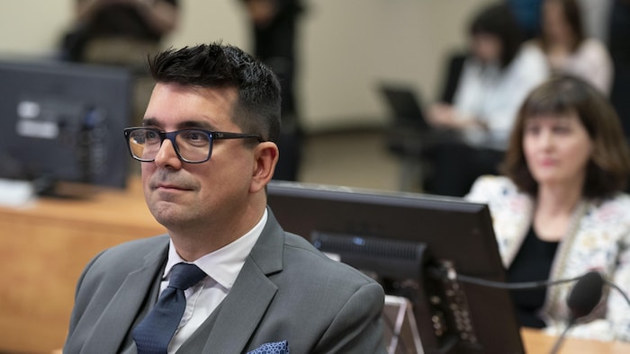 Me Tremblay assis dans la salle de la commission.