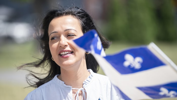 A Quebec woman and flag. saint-jean-baptiste: montreal fleurdelisé overwhelming heat saint-jean-baptiste: montreal fleurdelisé overwhelming heat new
