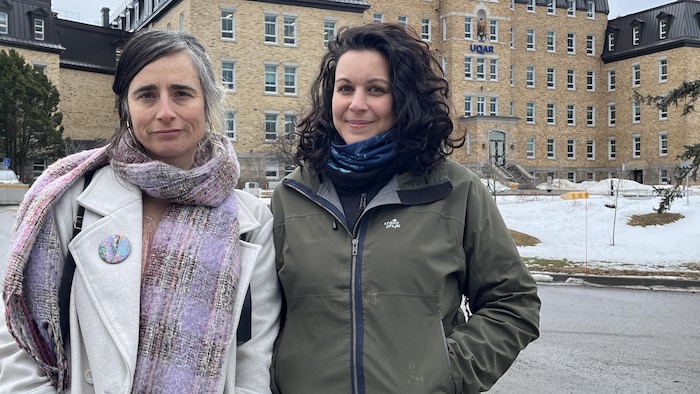 Une photo de devant d'Esther Dion-Poulin et de Jeny Sarraf devant les bâtiments de l'UQAR.