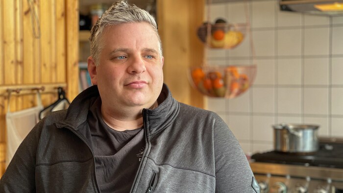 Portrait de l'homme dans sa cuisine.