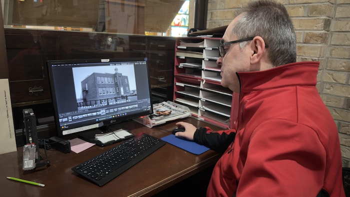 Louis Audet regarde des images sur un ordinateur.