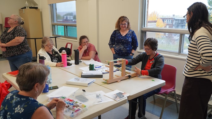 Des membres du Cercle des fermières de Sherbrooke lors d'un atelier de tissage.