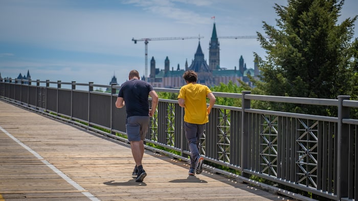 Deux hommes font du jogging sur le pont Alexandra.