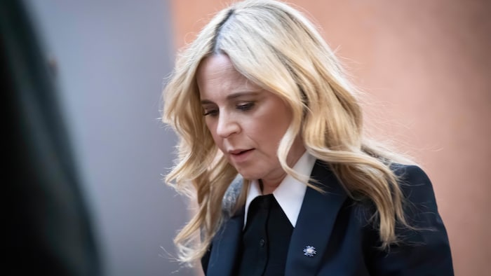 Julie Snyder, serious, looks on the ground.