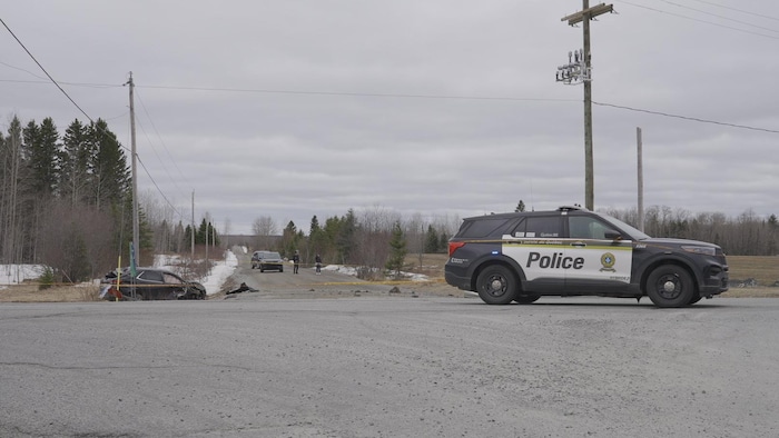 Une voiture accidentée est protégée par une autopatrouille de la Sûreté du Québec.