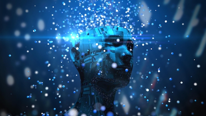 Une illustration en trois dimensions représentant un buste bleu dont le haut du crâne a été retiré pendant qu'une pluie de billes lumineuses lui tombe dessus.