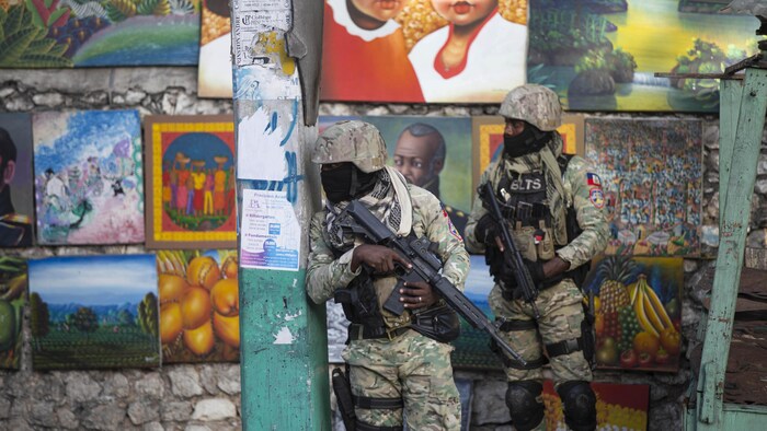 Soldiers stand guard in a street in Port-au-Prince.