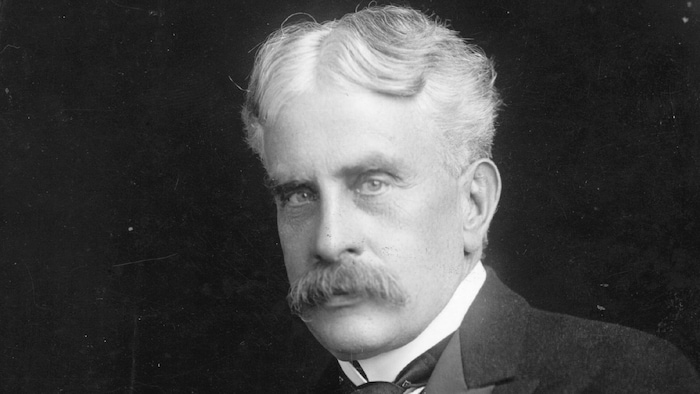 Robert Borden poses in a black and white photo.