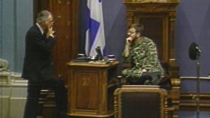 À l'Assemblée nationale du Québec, un homme discute avec un militaire qui est assis sur un trône.