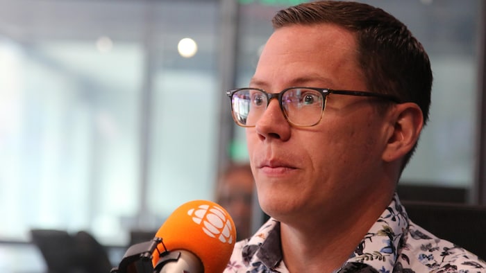 A man behind a microphone.