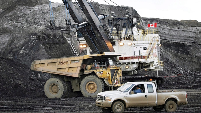A mining shovel fills a haul truck at an oil sands mine near Fort McMurray, Alberta.