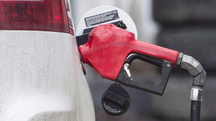 A pistol of a fuel pump in a car. carney promised significant changes canada's