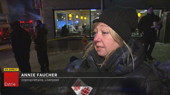 A woman speaks to the camera.