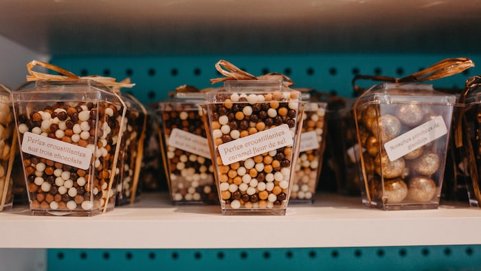 Un étalage de produits chocolatés de l'Artisan du dessert, dont des perles croustillantes caramel et fleur de sel.