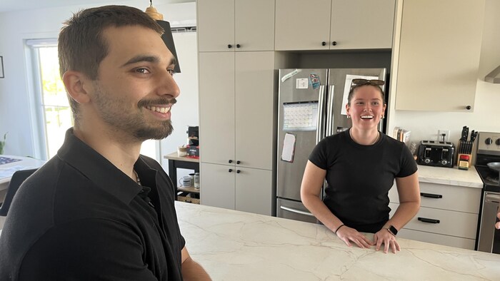 Kirk Fryer, appuyé sur son ilot de cuisine, s'esclaffe en compagnie de sa conjointe, Daphné Dionne.