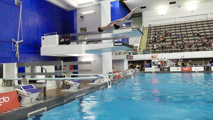 Un garçon dans l'air pendant un plongeon.