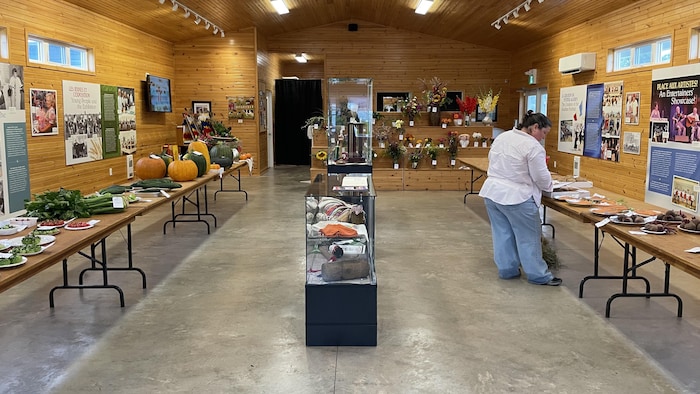 Une salle remplie de légumes, grains et fleurs prêts à être jugés.