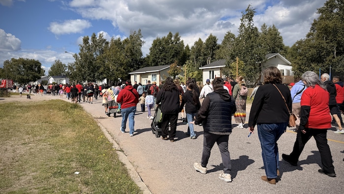 Beaucoup de gens marchent dans une rue.