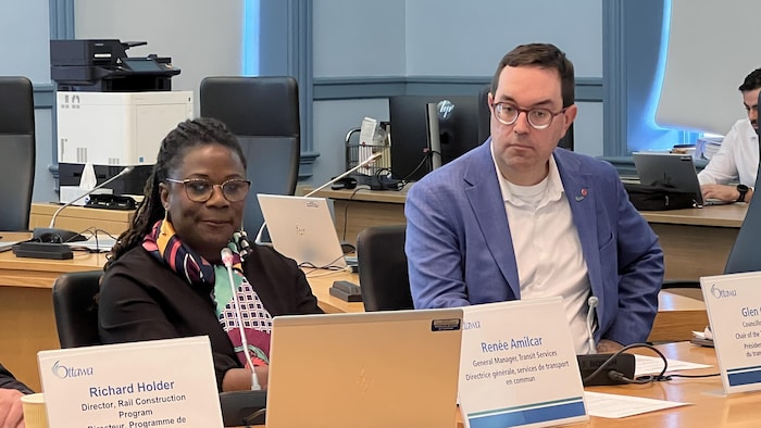 Renée Amilcar and Glen Gower are sitting at a table.