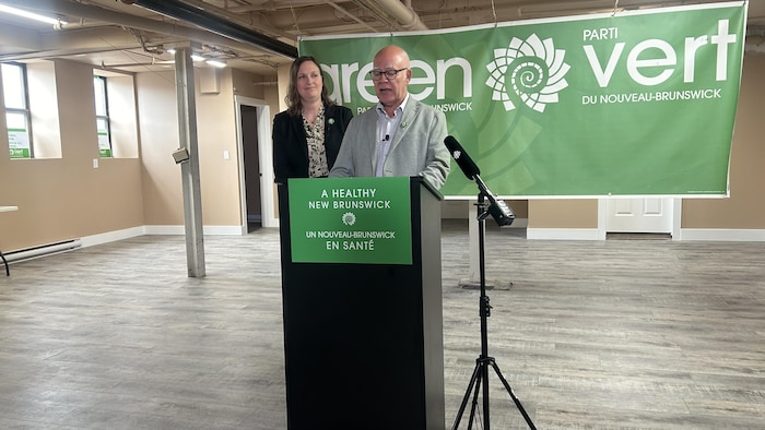 David Coon and Megan Mitton at the podium during an announcement. 