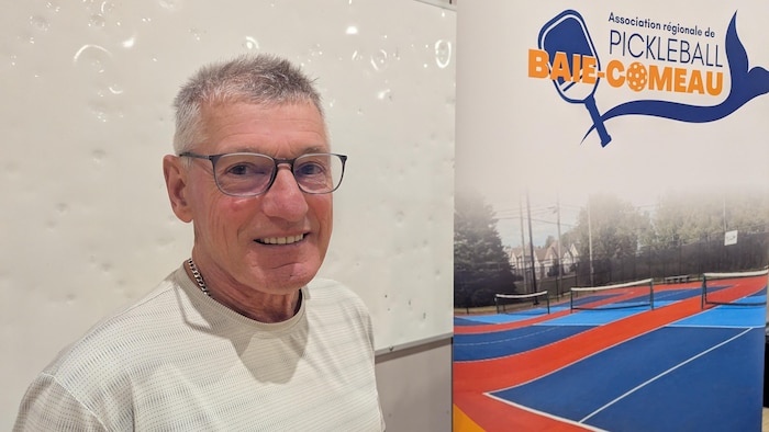 Yves Cyr à côté d'une bannière de l'ARPBC.