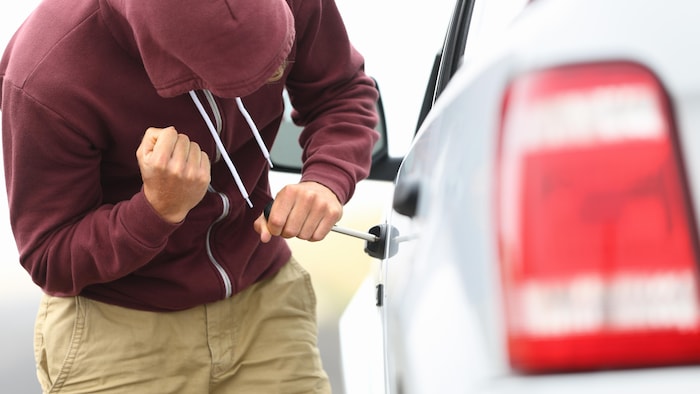 Un homme tente d'entrer dans un véhicule par effraction.