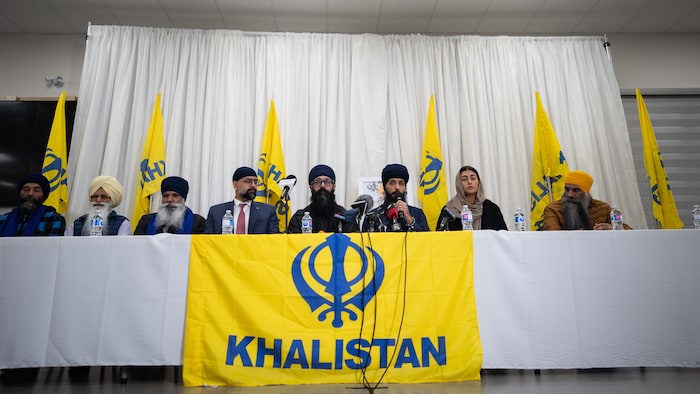 Jaskaran Sandhu, fourth from the left, from left to right, Head of the Sikh Federation of Canada Moninder Singh, Danish Singh, Gurpreet Kaur sit during a press conference at Guru Nanak Sikh Gurdwara in Surrey, B.C. on February 26, 2026