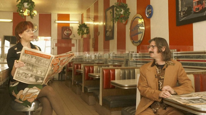 Chantal Lamarre and Jean-René Dufort discuss in an old restaurant. 