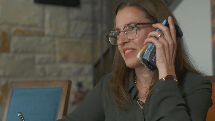 Isabelle Reid en conversation téléphonique.
