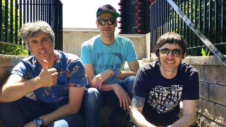 Trois hommes assis dans un escalier. 