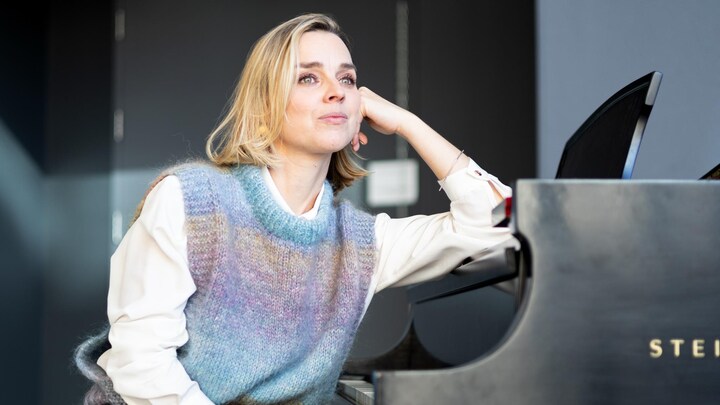 Portrait de Viviane Audet assise à un piano et regardant au loin.