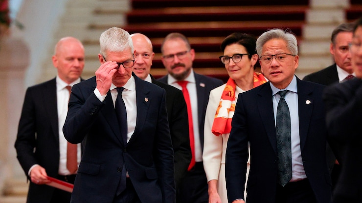 Nvidia CEO Jensen Huang, center right, Apple CEO Tim Cook, center left, and Citi CEO Jane Fraser, rear center, arrive for the meeting between Chinese Premier Li Qiang and U.S. business representatives, at the Great Hall of the People in Beijing, Thursday, May 14, 2026. (Go Nakamura/Pool Photo via AP)