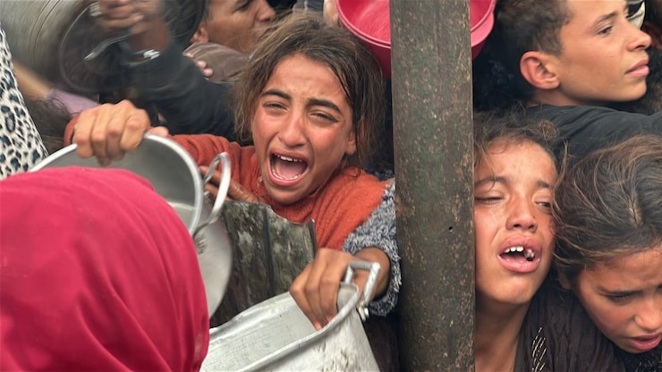 Children in a line at a food distribution kitchen in the south of Khan Younis City in southern Gaza Friday. 