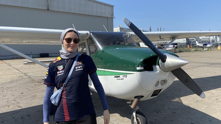 امرأة أمام طائرة.