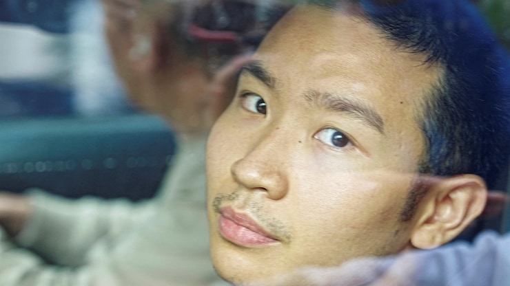 Hong Kong student Miles Kwan, 24, part of a group that launched a petition demanding an independent probe into possible corruption and a review of construction oversight over a deadly fire at the Wang Fuk Court housing complex, leaves a police station following his detention, in Hong Kong, China, December 1, 2025. REUTERS/Lam Yik     TPX IMAGES OF THE DAY