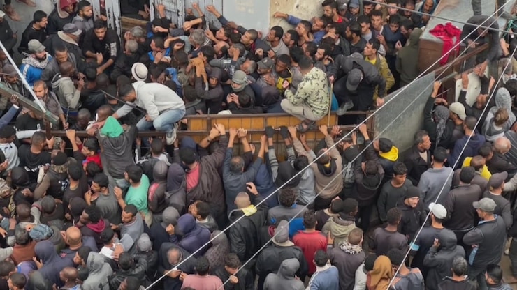 Hundred of people crammed in front of a bakery in Deir el-Balah in central Gaza Friday, desperate to get bread for their families as the food crisis in the war-torn enclave worsens. 